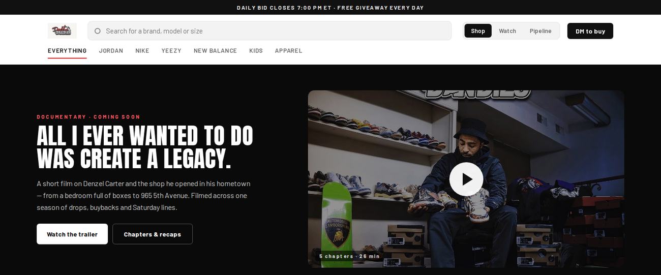 Homepage of deadstockdandies.com: the shop owner on the floor of his store holding a pair of sneakers.